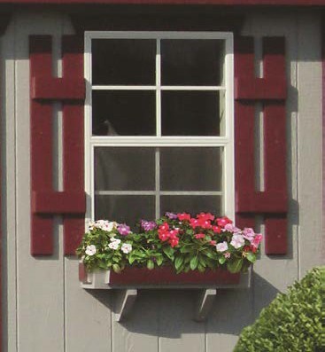 Shed window with shutters and a flower box